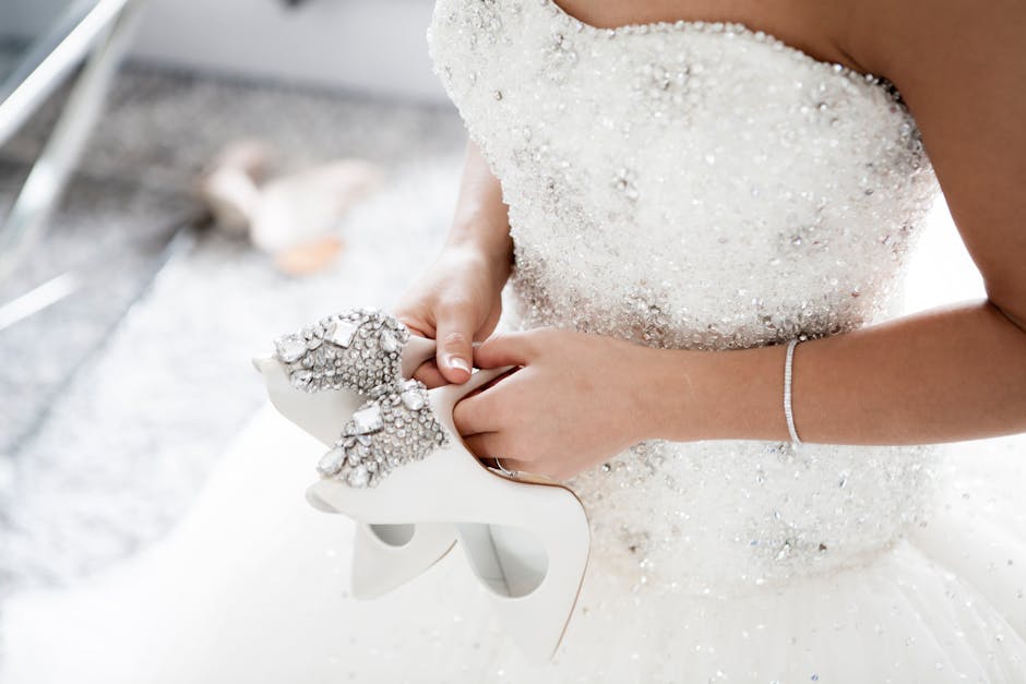 pexels photo 313702 313702 Bride in a dazzling wedding dress holding embellished high heels.